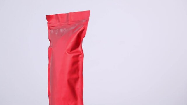 Zipper stand-up pouch spinning on light grey background, closeup. Space for text