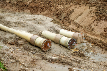 New fiber glass water pipeline in trench. Replacement of old rusty tubes by new one