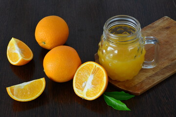 Fresh Orange Juice and Oranges on a Wooden Table