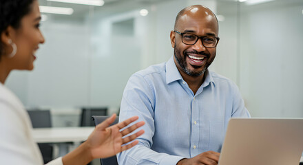Fototapeta premium Business Meeting Between a Man and a Woman in Modern Office Setting Engaged in Discussion and Collaboration