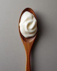 Creamy White Sauce on Wooden Spoon Against Neutral Background for Culinary Use