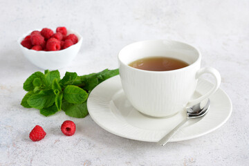 Raspberry Tea with Mint and Fresh Raspberries in a white cup
