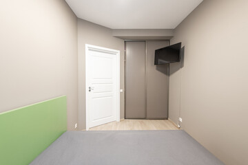 Modern Minimalist Bedroom Interior with Green and Gray Accents and Wooden Floor