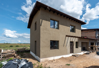 Modern Two-Story House Under Construction on a Sunny Day
