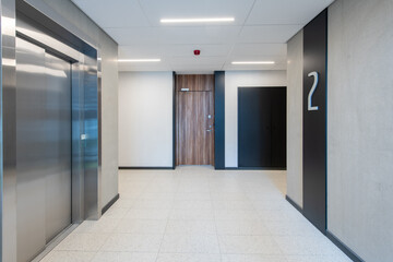 Modern Building Interior with Staircase and Elevator on the Second Floor