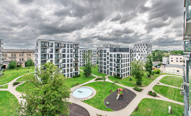 Modern Residential Complex with Green Spaces Under a Cloudy Sky