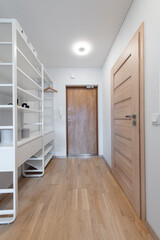Modern Home Hallway Interior with Shelving and Wooden Door Design
