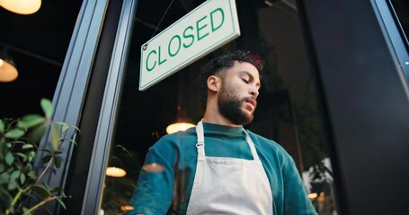 Closed, door and waiter with sign at cafe for public notice, no service and end of trading hours. Manager, below and man with board message at storefront for customer information and advertisement