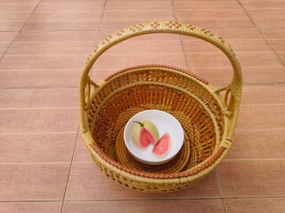  Red-fleshed guava halves sit a basket