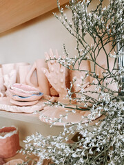 Artistic display of handcrafted pottery and decorative plants in a serene studio setting