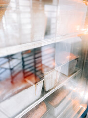 Baked goods cooling on metal racks in a bright bakery kitchen environment