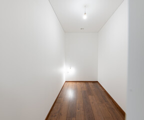 Empty White Room With Wooden Floor and Minimal Lighting Setup