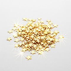 Sparkling golden stars scattered in loose formation over a clean white surface copy