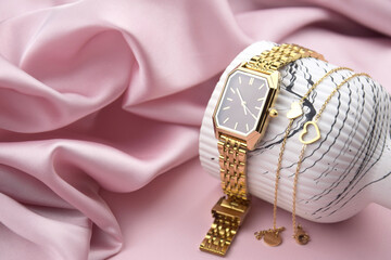 Closeup minimal fashion wristwatch for women on pink background.