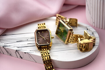Closeup minimal fashion wristwatch for women on pink background.