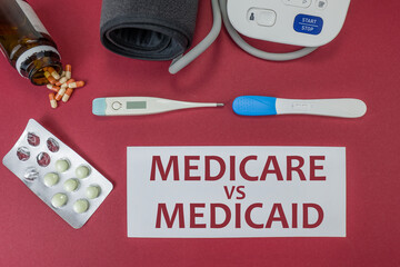 Medicare versus medicaid text on a red background
