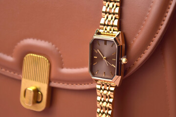 Closeup minimal fashion wristwatch for women on pink background.