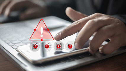 Close-up of businessman touching smartphone showing cybersecurity alert and data breach warning,...