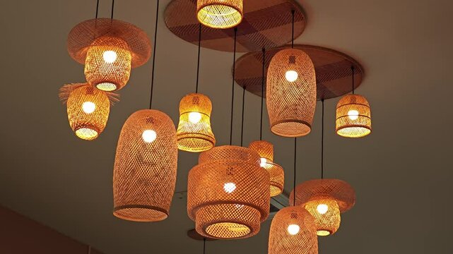 Hanging woven bamboo lamp with warm glowing lights.
