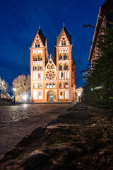 A cathedral in a city, beautifully illuminated at dusk. Morning in Limburg, Hesse