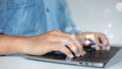 Man typing on a laptop with a glowing Artificial Intelligence (AI) processor chip hologram. Concept of machine learning, big data, and futuristic business process automation.