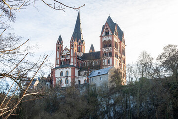 A cathedral in a city, beautifully illuminated at dusk. Morning in Limburg, Hesse