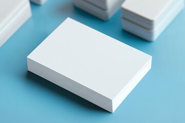 Minimalist blank business cards stack on blue background ready for custom design and branding