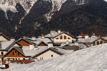 Snow Alps Village Winter: Picturesque mountain village rooftops covered in snow during winter...
