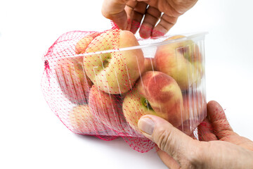 Donut flat peaches in the plastic basket