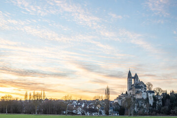 A winter landscape shot at sunrise. Plenty of nature and a large church on a rock. The former collegiate church of St. Lubentius Limburger, Dietkirchen, Hesse