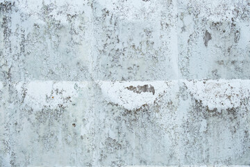 Urban texture with peeling paint on an old concrete wall in a city environment showcasing wear and...