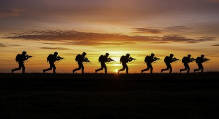 Fototapeta premium Nine soldier silhouettes running with rifles across a field at vibrant sunrise