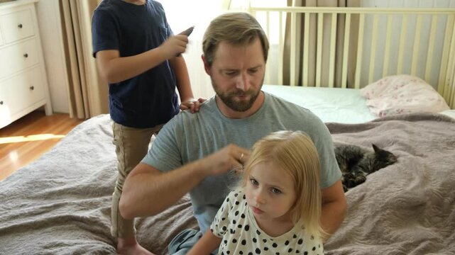 Man brushing daughters hair. Daddy combing girl's hair at home. Responsible good dad braiding daughters hair. Handsome father grooming his little one. Morning routine concept. Family life