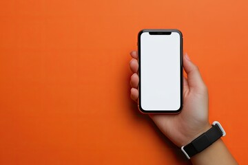 Detailed Color Picture of Fitness Tracker on Female Hand on Orange Background and Smartphone