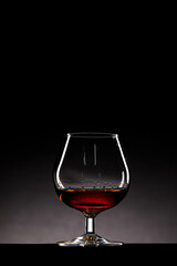 Elegant Glass of Amber Liquid on a Dark Background, Capturing the Rich Color and Reflected Light Creating a Captivating and Sophisticated Still Life Image Perfect for Beverage Enthusiasts