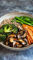 A bowl with cooked buckwheat, carrot, broccoli, mushrooms, peas and sesame seeds