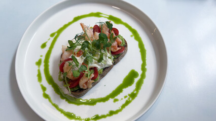 Delicious Shrimp and Avocado Toast with Cherry Tomatoes, Fresh Greens, and a Flavorful Green Drizzle: A Culinary Delight for any Gastronomy Enthusiast