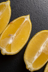 Lemon slices on black background close-up. Freshness concept, making Lemonade with lemon slices....