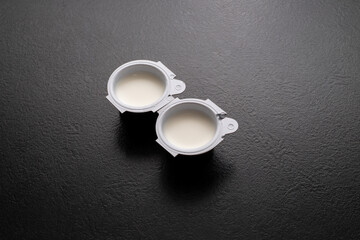 Small milk, coffee creamer pots on red. Mono portions, for catering etc.
Coffee creamer.
Single...