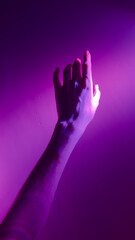 An Artistic Representation of a Hand Reaching Out Against a Background of Vibrant Purple Light Create a Captivating Visual Experience
