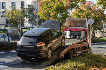 A Car Loaded on a Tow Truck