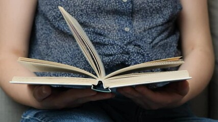 A book in hands, pages turning, slow motion. The concept of wisdom and knowledge