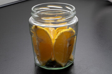 Lemon slices in a glass in a jar. Freshness concept, Lemonade with lemon slices in a jar on a black...