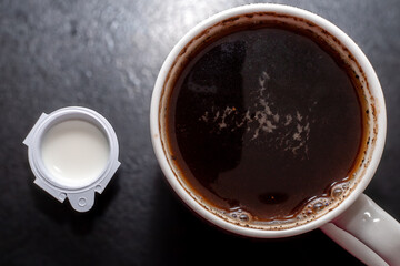 Detail of milk mixing in coffee drink, flat texture. Fresh beverages background