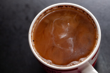 Detail of milk mixing in coffee drink, flat texture. Fresh beverages background