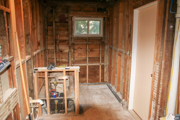 Bathroom Renovation Project in Partially Stripped Interior by Window