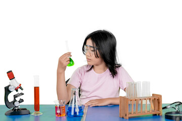 Curious young girl conducting science experiment with colorful liquids in laboratory