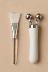 Facial brush with clear gel and microcurrent device on beige background. Professional skincare tools for salon treatments and at-home beauty routines.