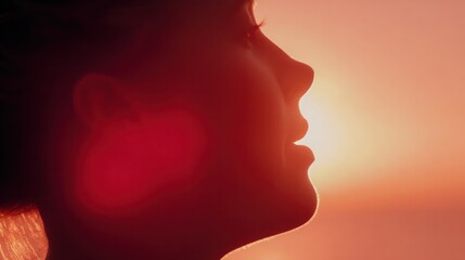 Expectant mother’s silhouette with glowing baby form against golden sunset, capturing warmth and care