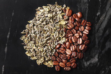 Dried tea leaves and roasted coffee beans on black marble background. Yin yang style round shape...
